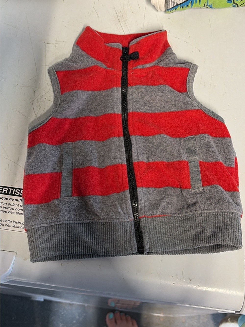 Carters size 6m baby boy zippered vest with gray and red stripes on it